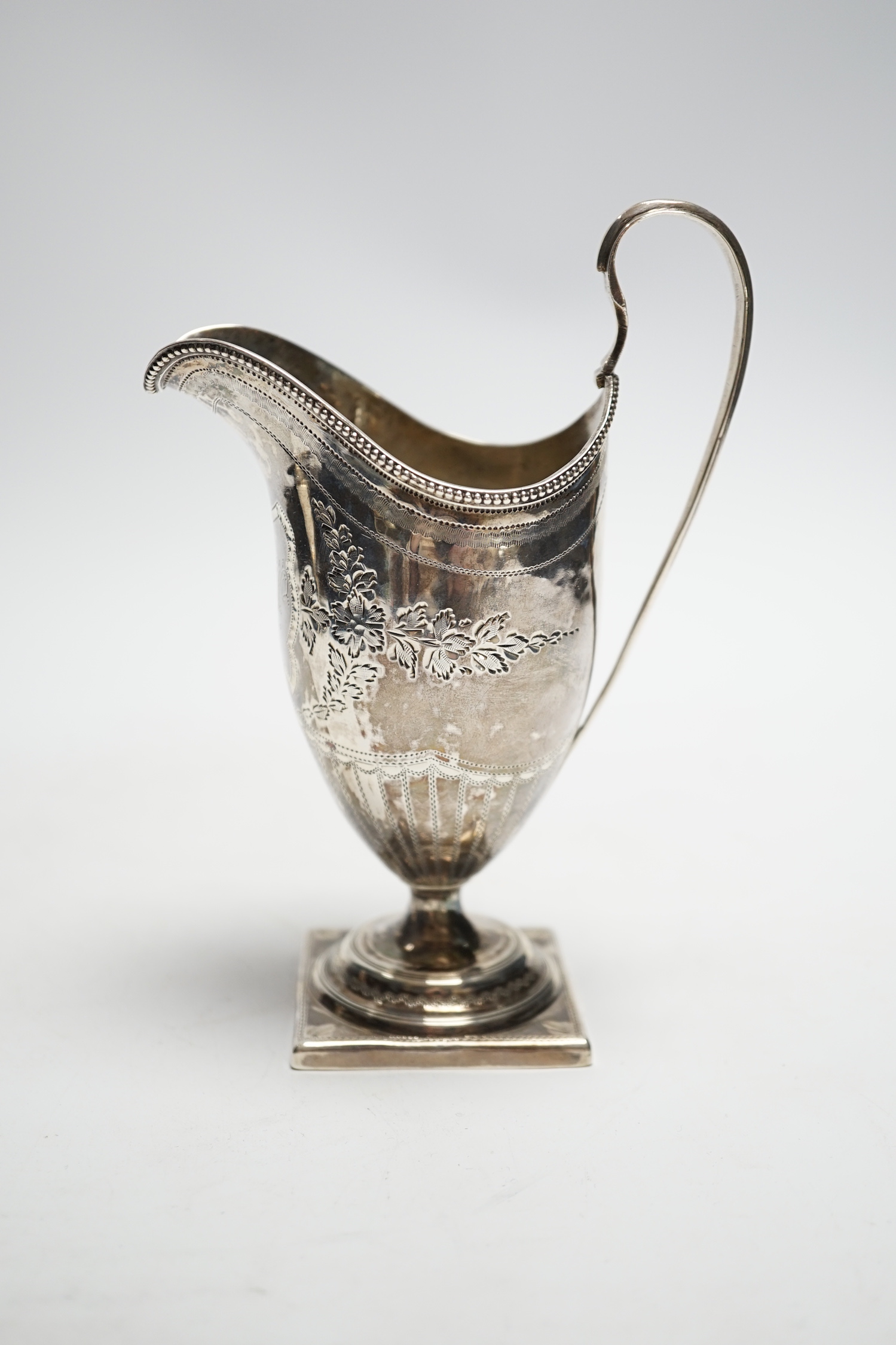 A George III engraved silver helmet shaped cream jug, on square foot, Soloman Hougham, London, 1796, 15cm, 3.6oz.